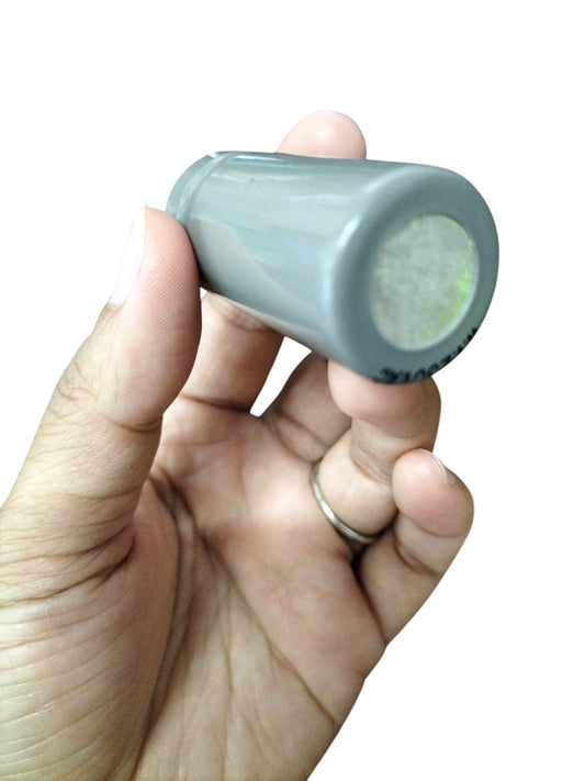 DRE 250 VAC Motor Running Capacitor held in hand, showcasing its compact and cylindrical design