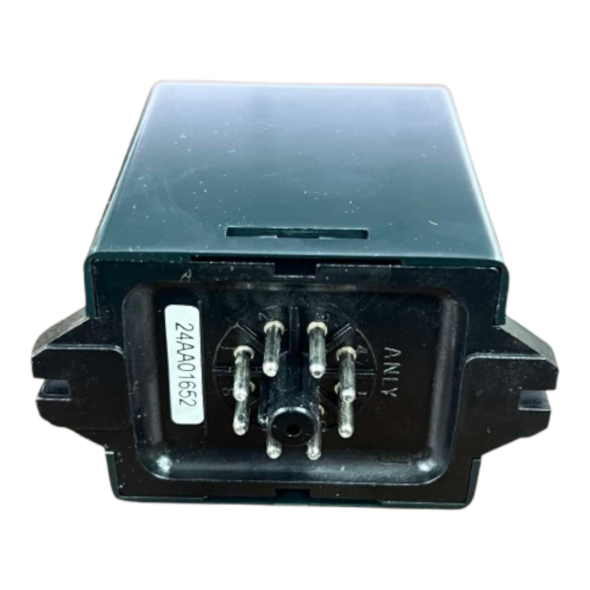 Black electronic component with terminal pins on a white background