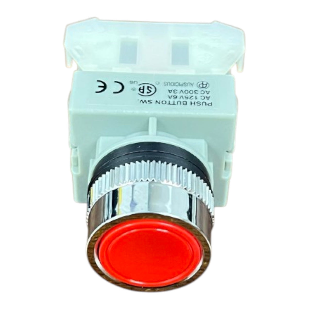 A push button switch module with a red circular button face, a silver metallic ribbed bezel, and a light green plastic housing with printed technical specifications and certification marks.