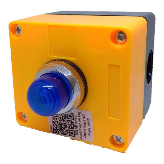 A square industrial push-button box with a bright yellow front casing, a blue translucent button cover, and a silver-rimmed center. The side of the box is dark gray/black, and a white product label is attached near the bottom left.