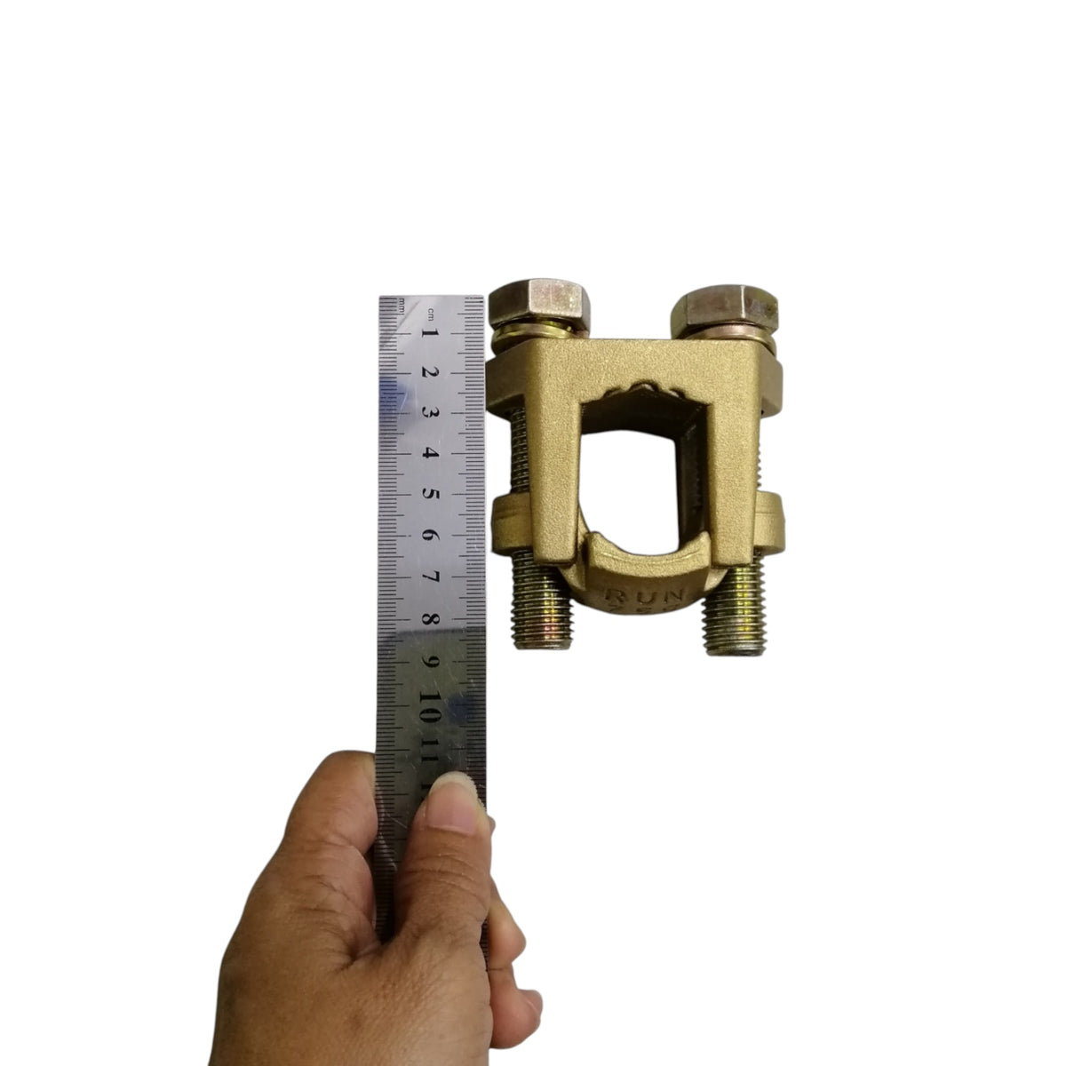 B-B Solderless Connector 2 Bolt brass ground clamp shown with ruler and hand for size reference B-B Solderless Connector Double Bolt 380mm - 500mm Copper 750-1000MCM Electx Electrical Supply