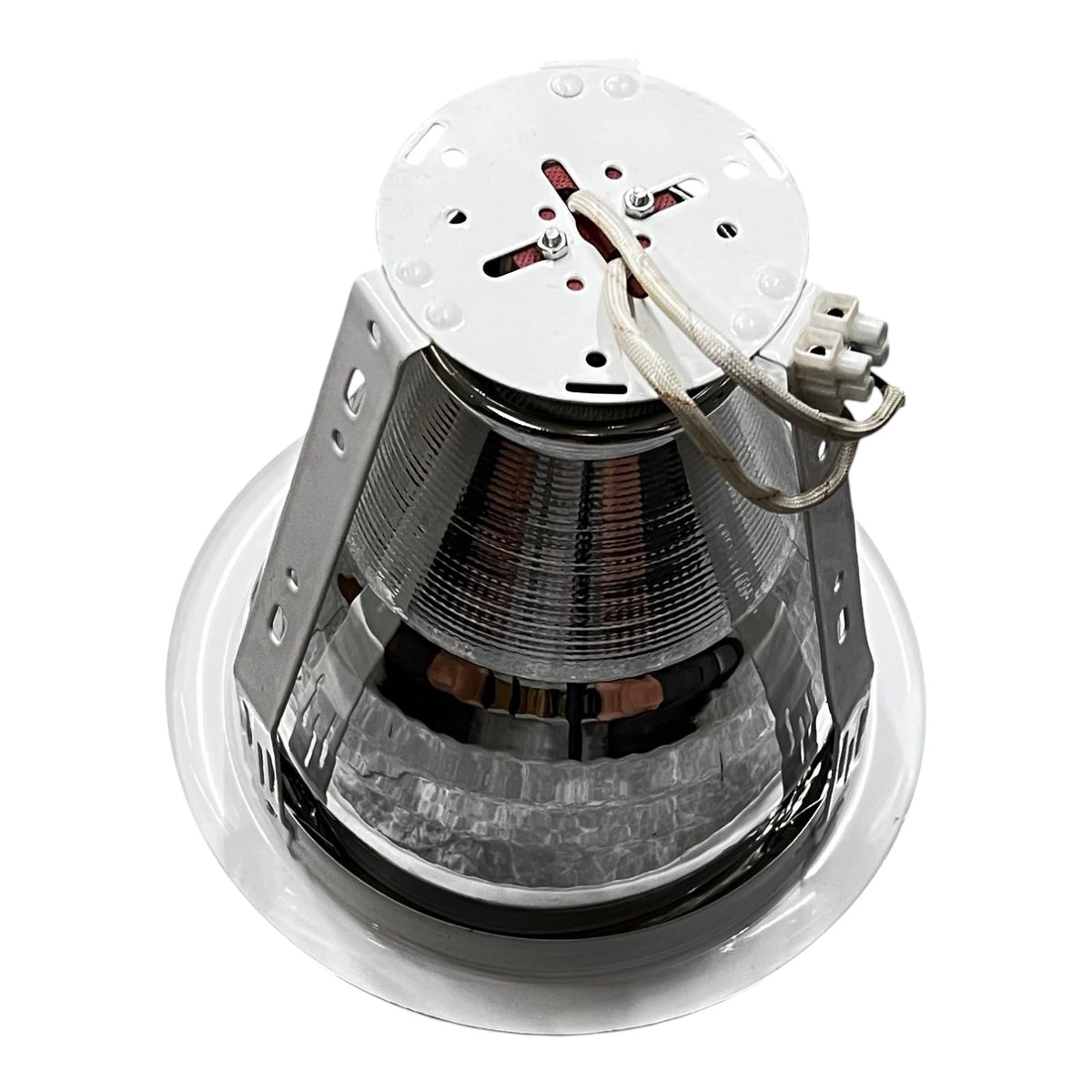 Metallic cone-shaped object with a white top on a white background