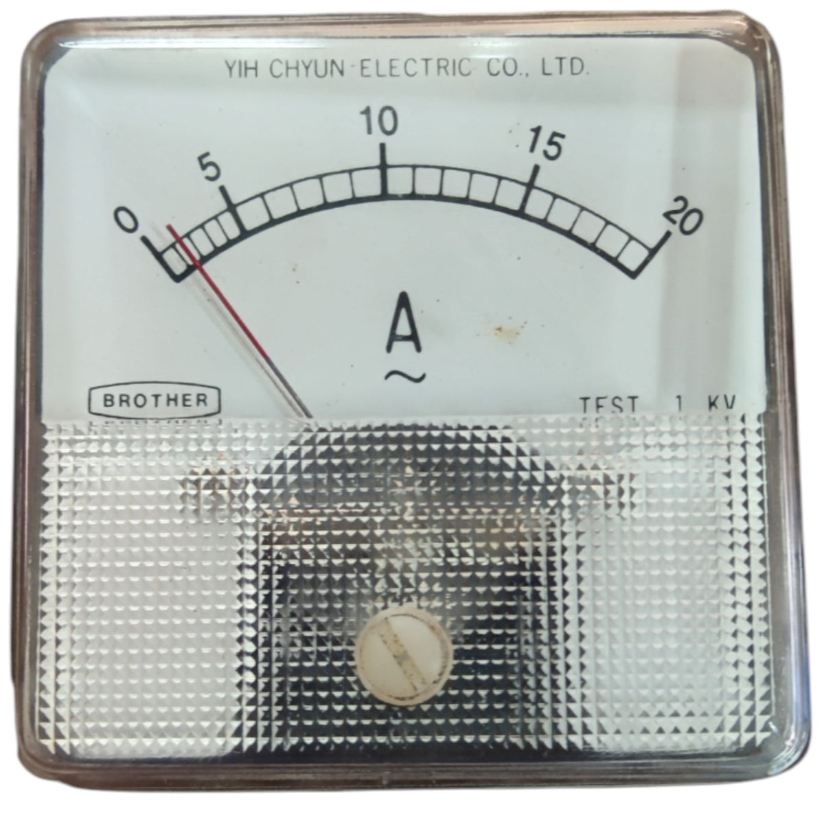 An analog ammeter with a clear protective glass cover, featuring a white dial face with black markings, a red needle, and a textured lower section. The brand 'YIH CHYUN ELECTRIC CO.