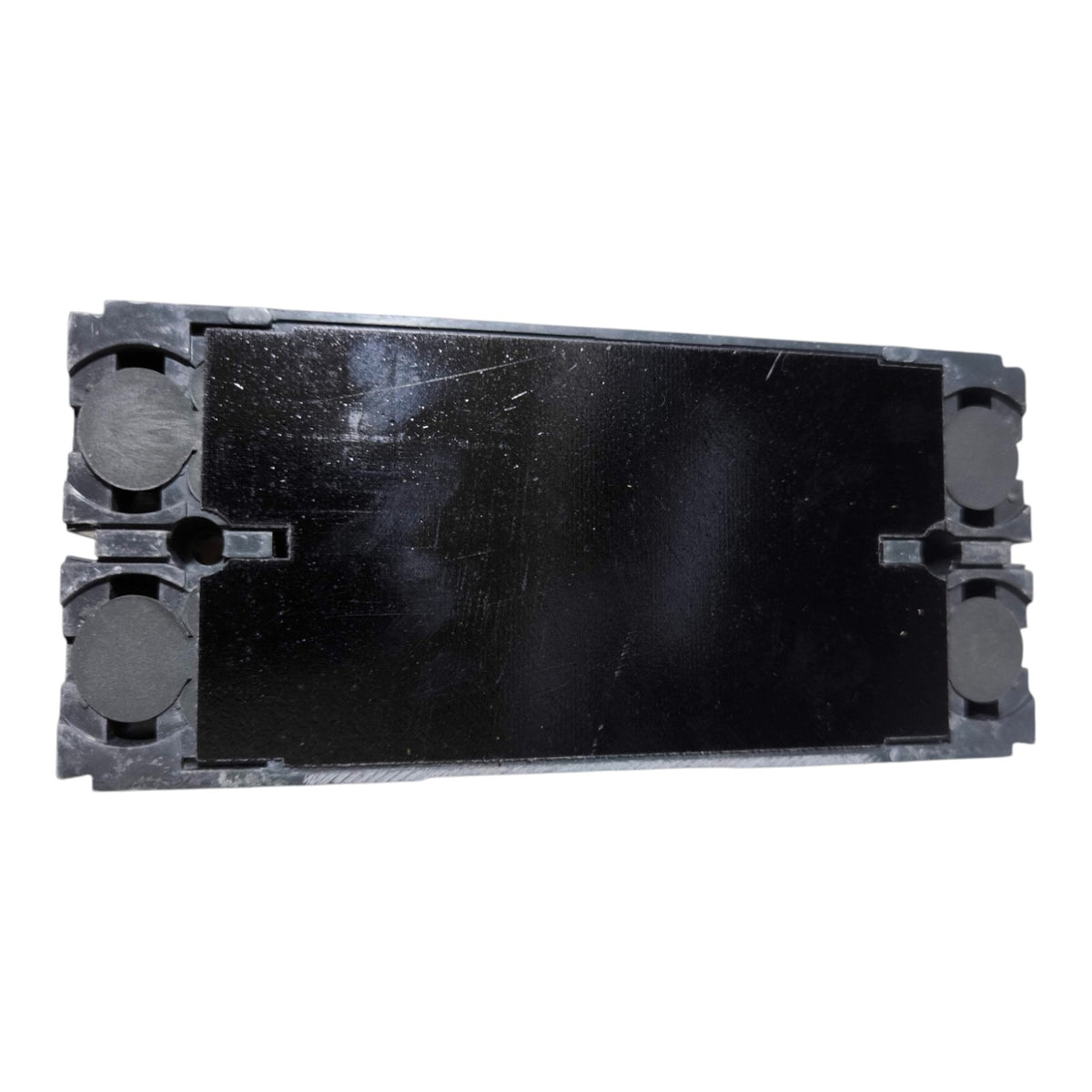 A black rectangular plastic component with circular cutouts on the left and right sides, shown on a plain white background.