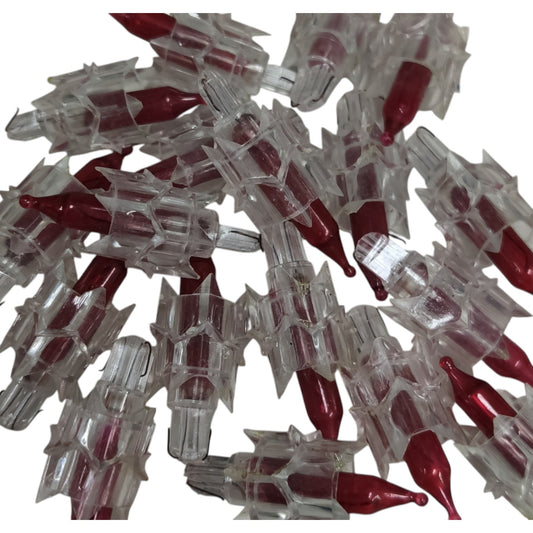 Pile of red and clear plastic capsules on a white background