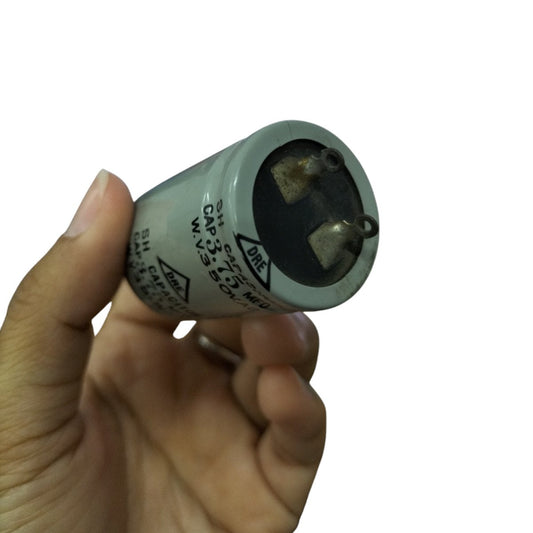 DRE 350V AC motor running capacitor held in hand for electrical circuit applications