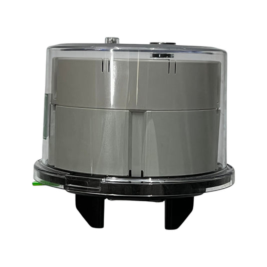 Round metallic object with transparent top on a white background