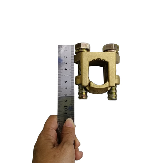 B-B Solderless Connector 2 Bolt brass ground clamp shown with ruler and hand for size reference