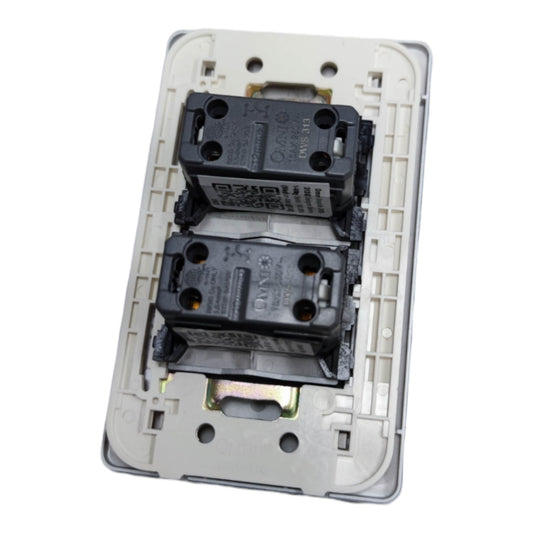 A two-way electrical switch module with two black contact modules mounted on a light gray plastic backplate, shown against a plain white background.