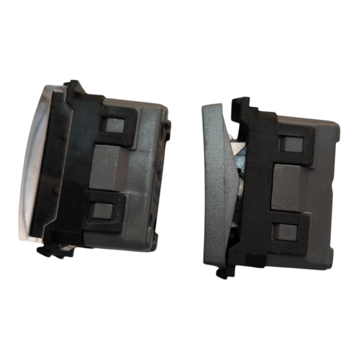 Two black plastic automotive switch modules shown from different angles on a white background.