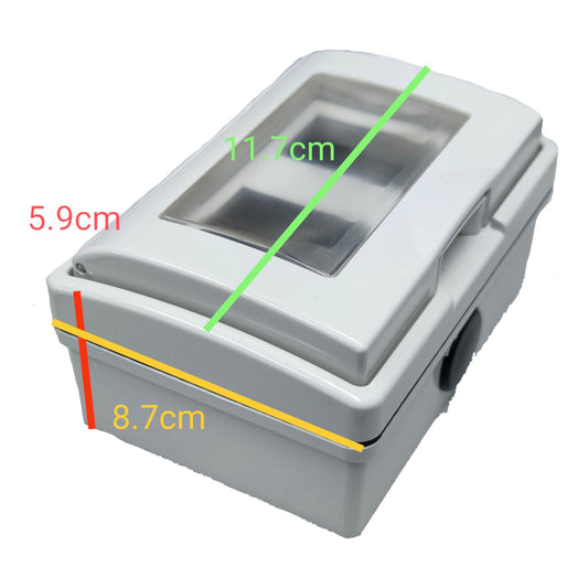A gray plastic device with a transparent top window, shown with overlaid dimension lines and measurements in centimeters: 11.7 cm across the top, 8.