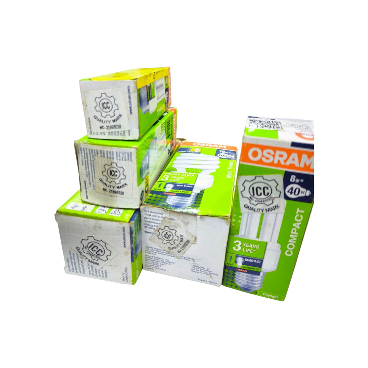 Five boxed compact fluorescent light bulbs from OSRAM ICC Quality Mark, stacked and arranged on a plain white background.