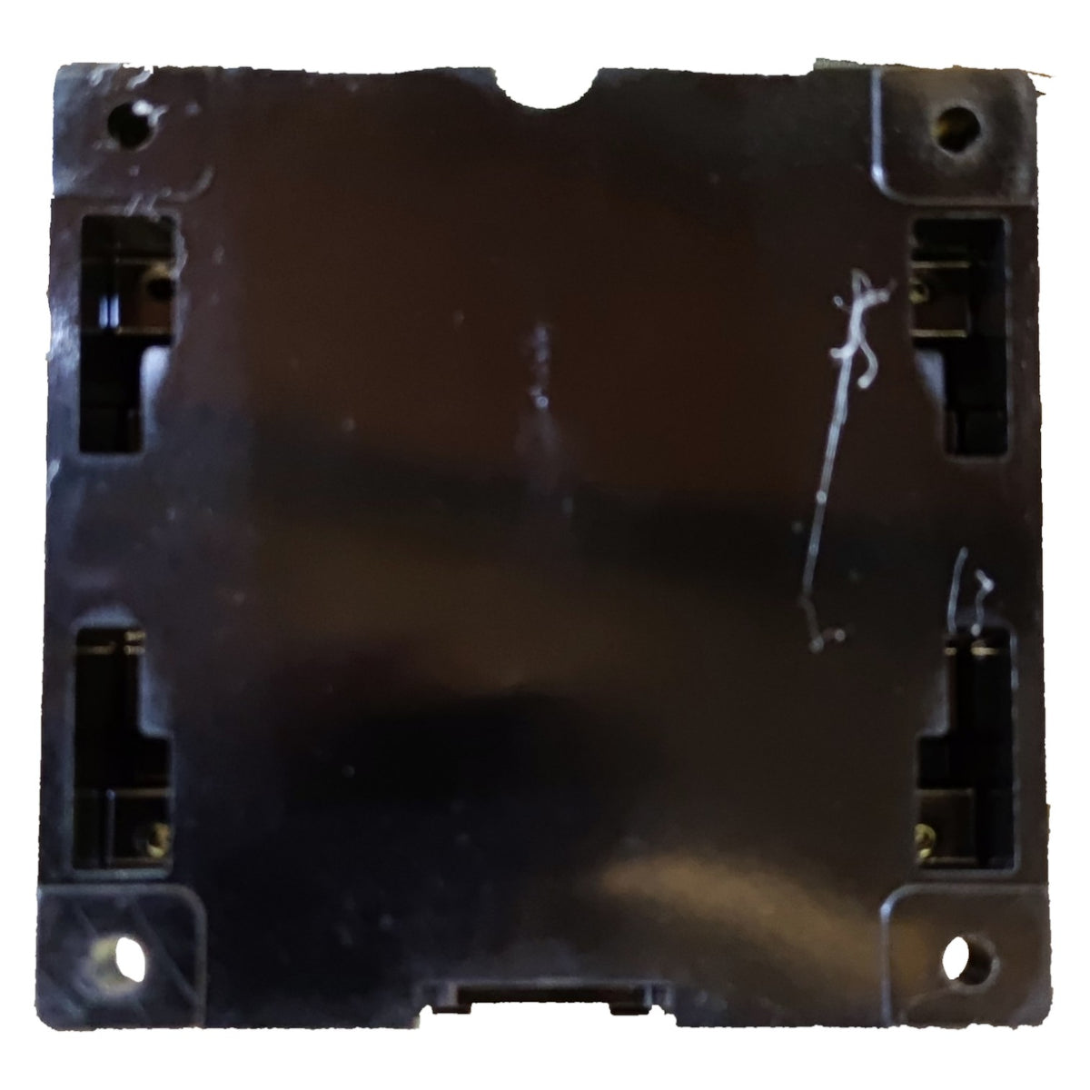 Black plastic component with multiple holes on a white background
