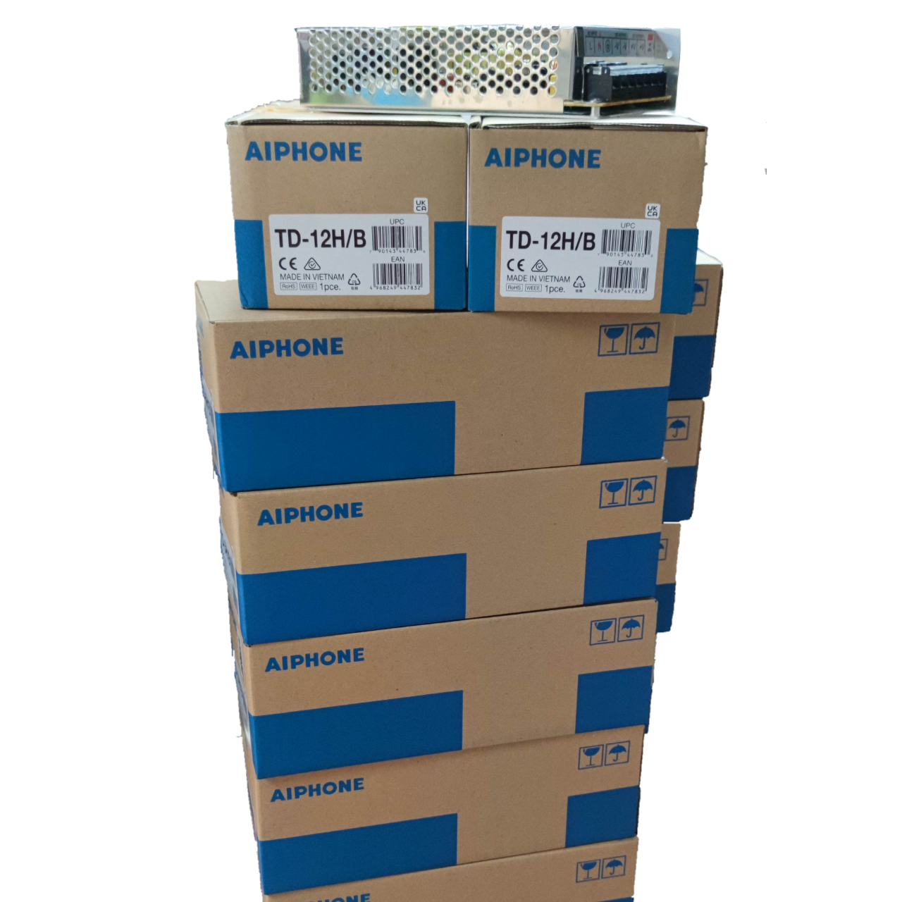 Stack of Aiphone 12 station intercom system boxes with security system equipment on top