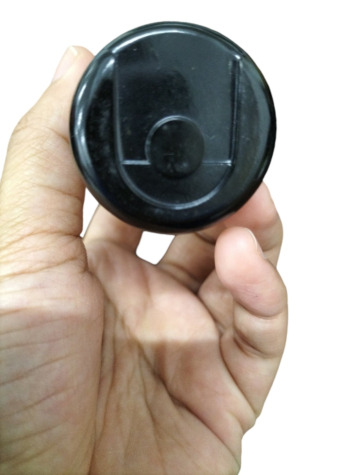 Hand holding BMI 243-292MFD Motor Starting Capacitor in black, used for motor efficiency