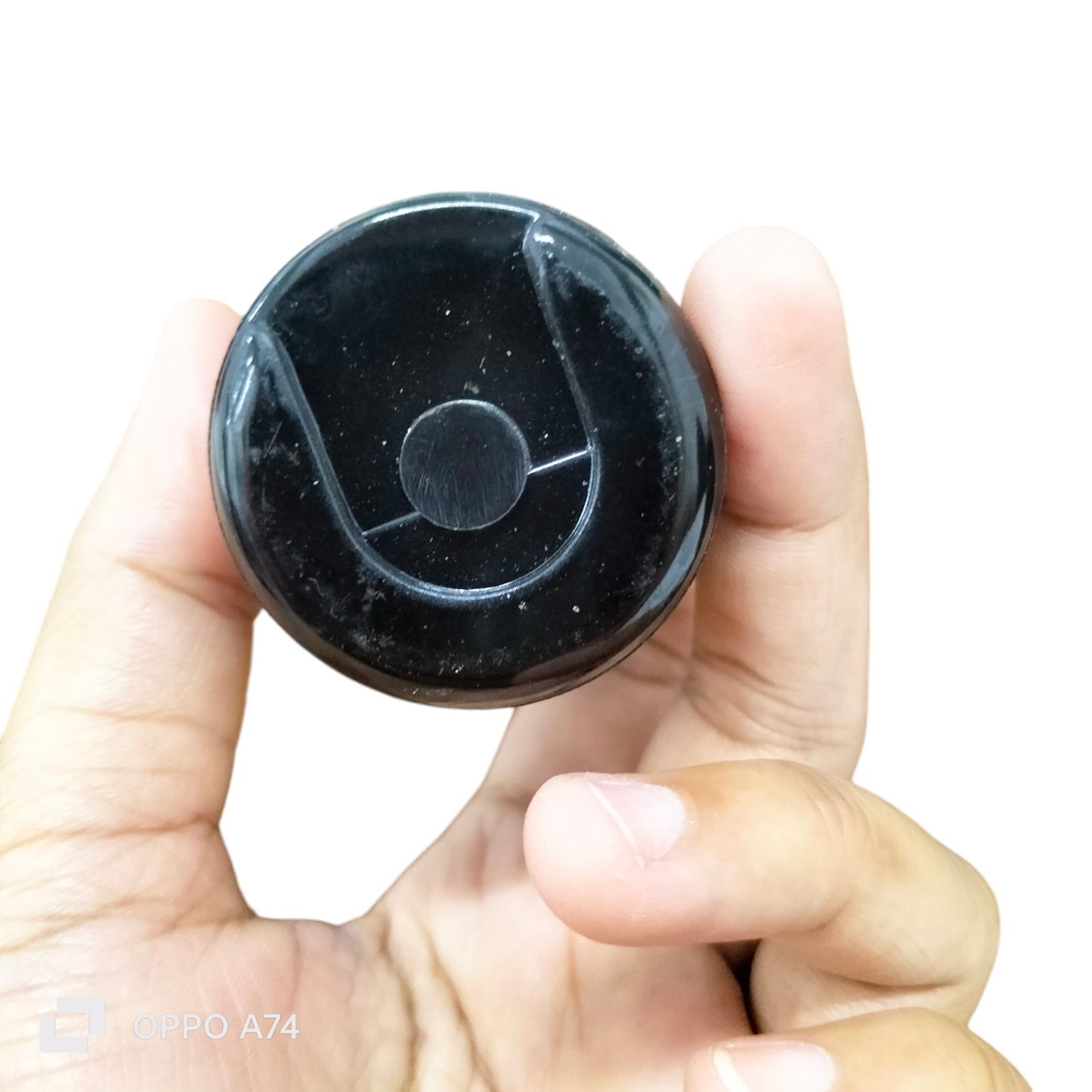 BMI Motor Starting Capacitor 270-324 UF held between thumb and finger for electrical circuitry