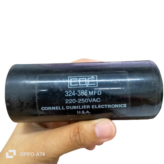Starting Capacitor CDE Brand 324-388 MFD black cylindrical electrical component held in hand