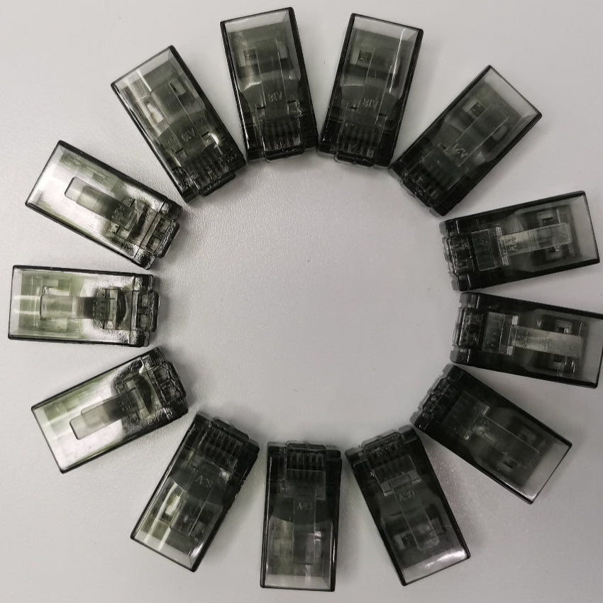 Circle of transparent black Denko RJ45 Connector colored adapters for powerline network connections