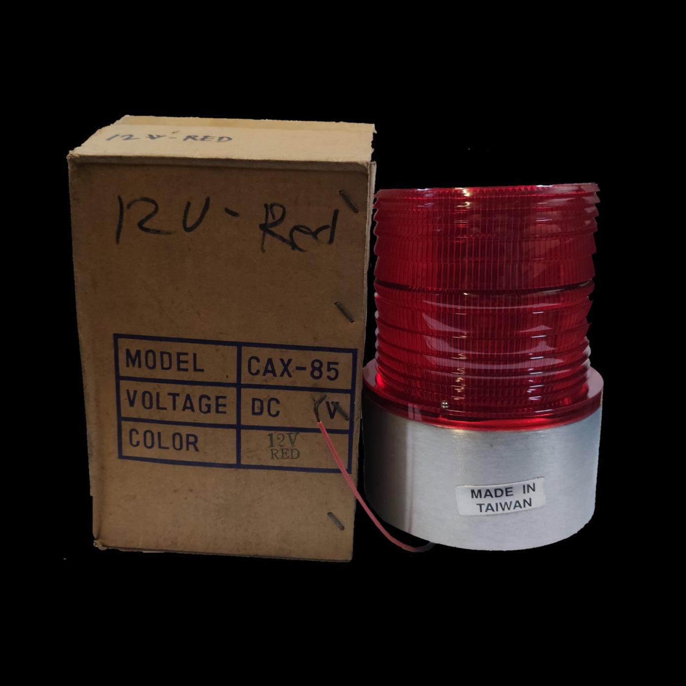 Sub Zero seasonal decorative flashing light red 12V DC with red lens and silver base next to cardboard box