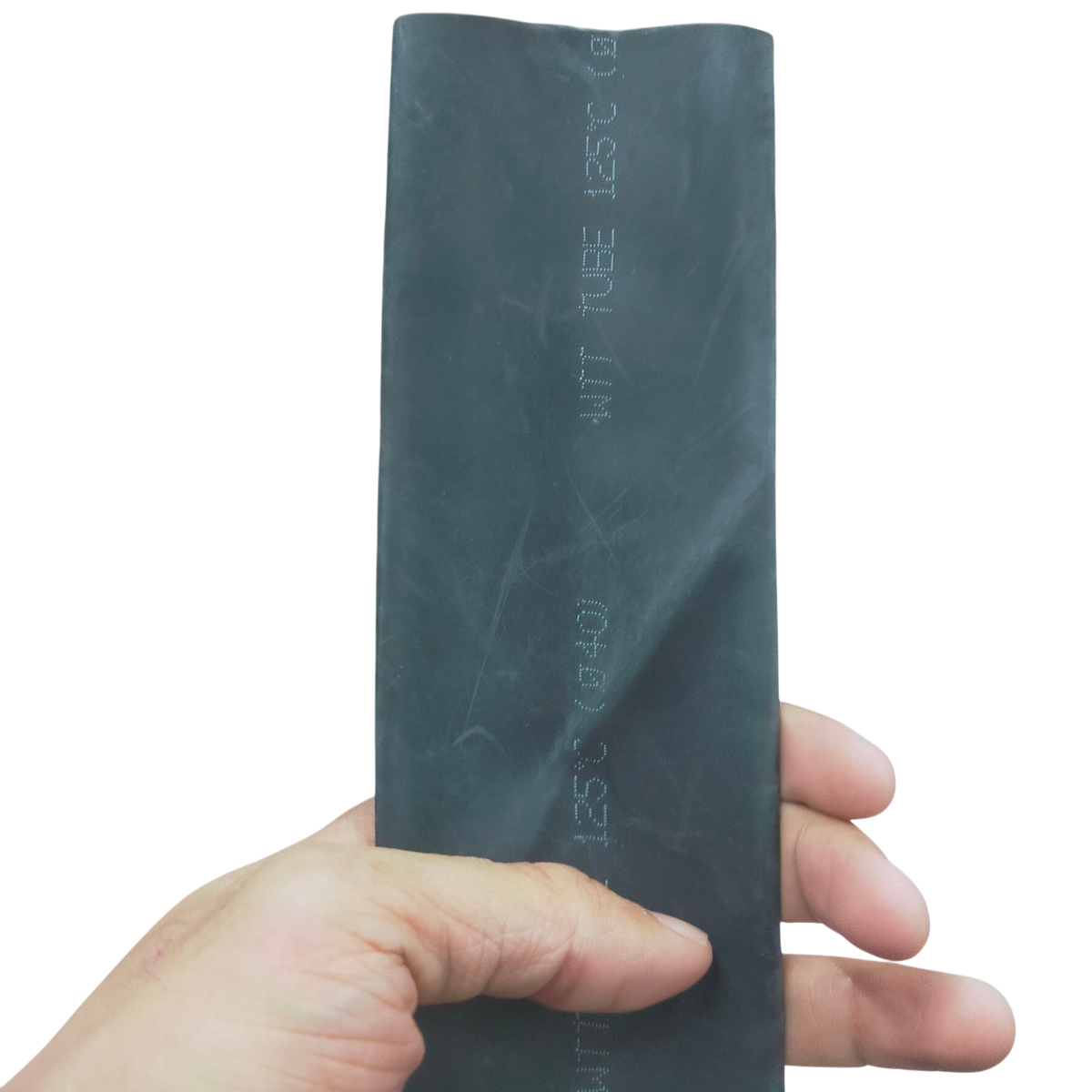 Hand holding a black heat shrinkable tube black for cable management from China