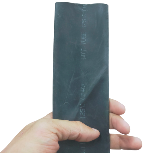 Hand holding a black heat shrinkable tube black for cable management from China