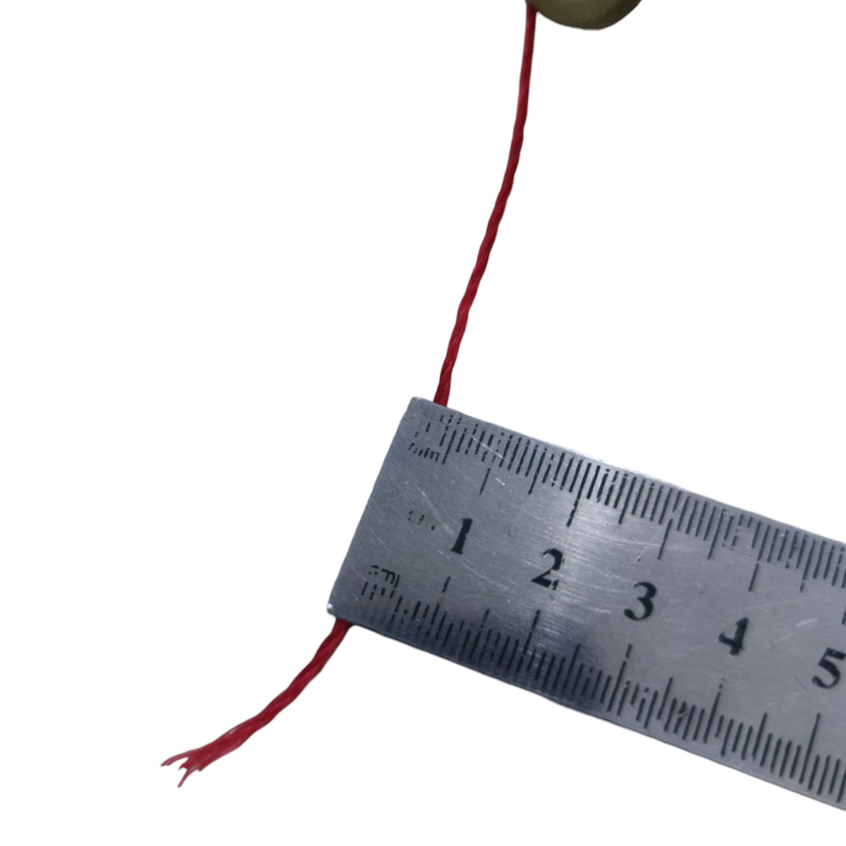 Red industrial nylon rope spool with measuring ruler for accurate gauge of thickness.