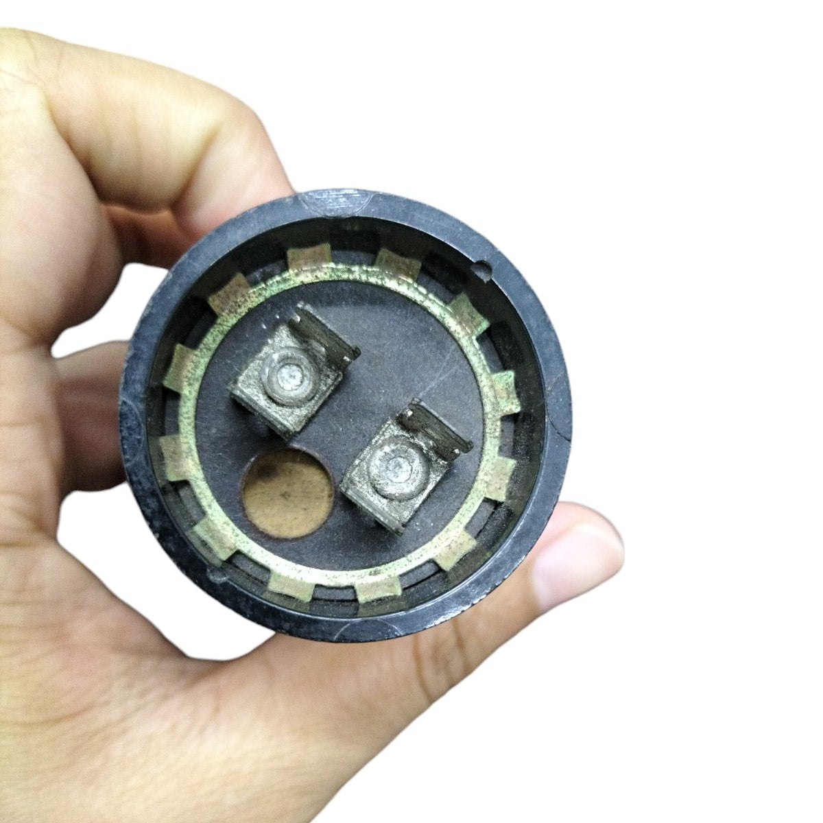 Mallory Motor Start Capacitor 243-292 MFD showing electrical terminals held in hand