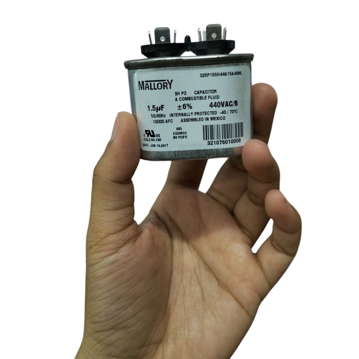 Mallory oil-filled running capacitor 440V AC held in hand, featuring a 1.5µF rating for reliable performance