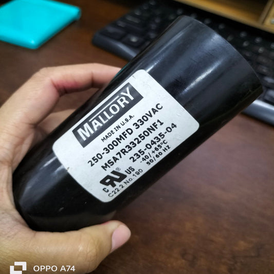 Mallory Starting Capacitor 250-300 MFD 330 VAC held in hand for electrical circuitry use