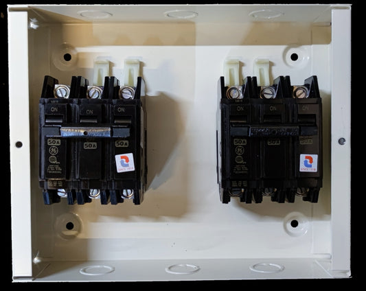 MTS 50A 3 Pole Three Phase electrical circuit breakers from Koten and GE mounted inside a white metal panel