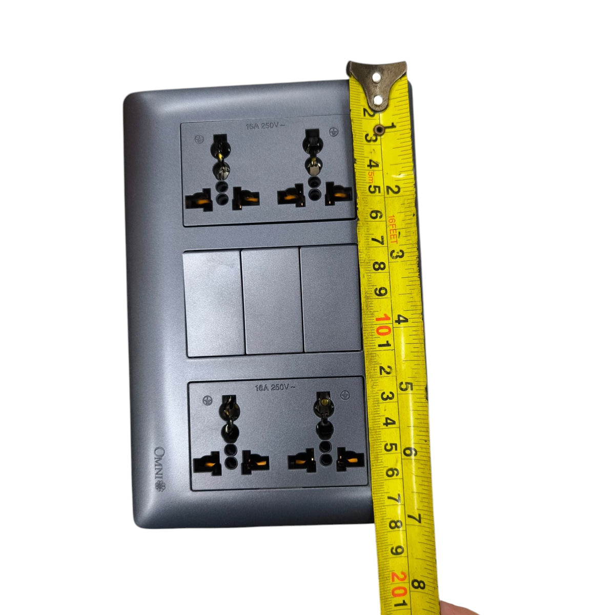 Omni 3 gang switch with 4 gang universal outlet shown with measuring tape for size reference