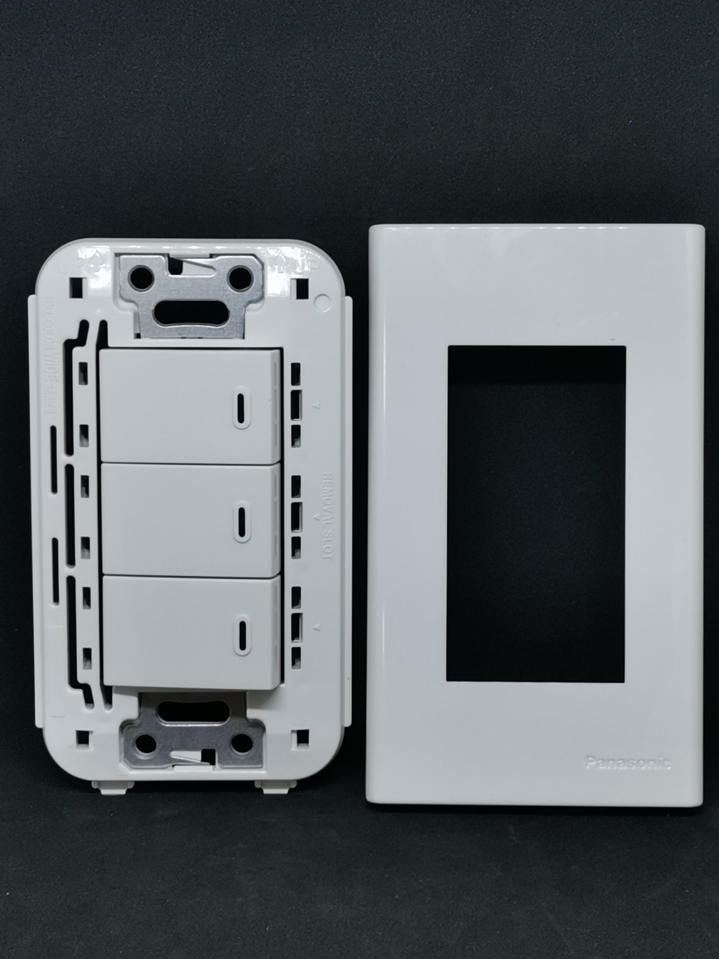 Panasonic Wall Switch 3 Devices WEG5001-K white triple rocker module with matching faceplate on black background