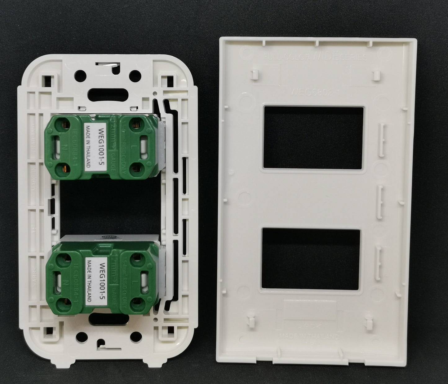 Panasonic WEG1001-5 WEG6802 outlet components with two green sockets in a white wall plate
