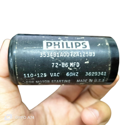 Philips Brand 72-86 MFD 110-125VAC black electrical motor start capacitor held in hand