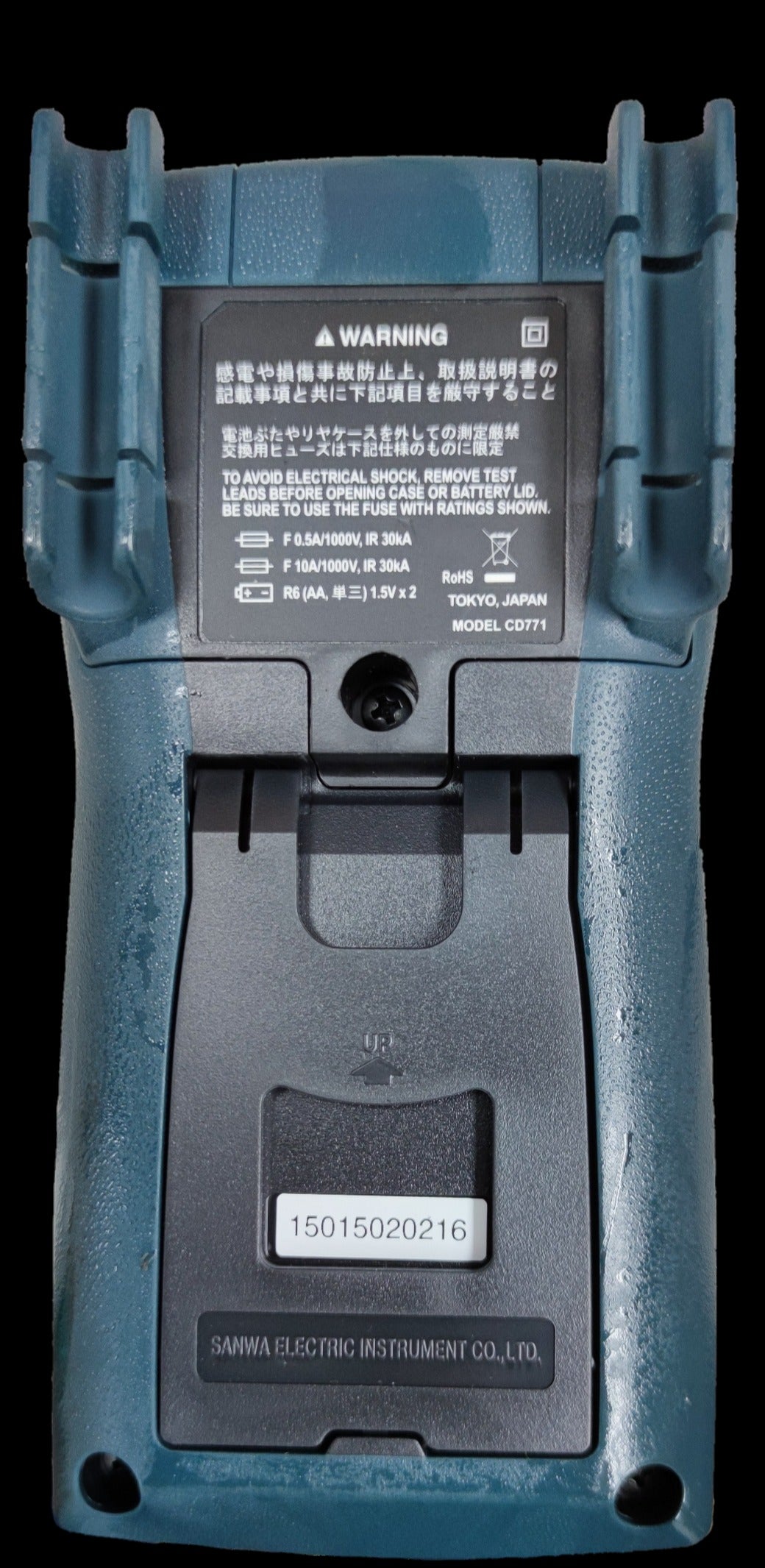 Back view of Sanwa CD771 Digital Multimeter showing battery compartment and warning labels