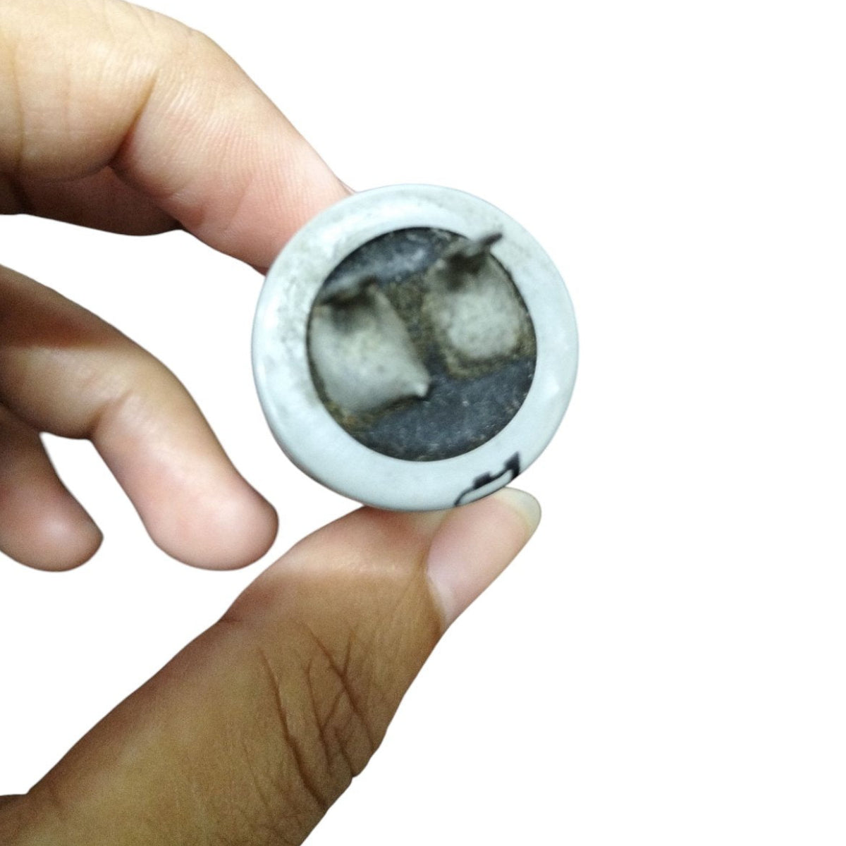 Hand holding a 350V AC Motor Running Capacitor showcasing its compact design