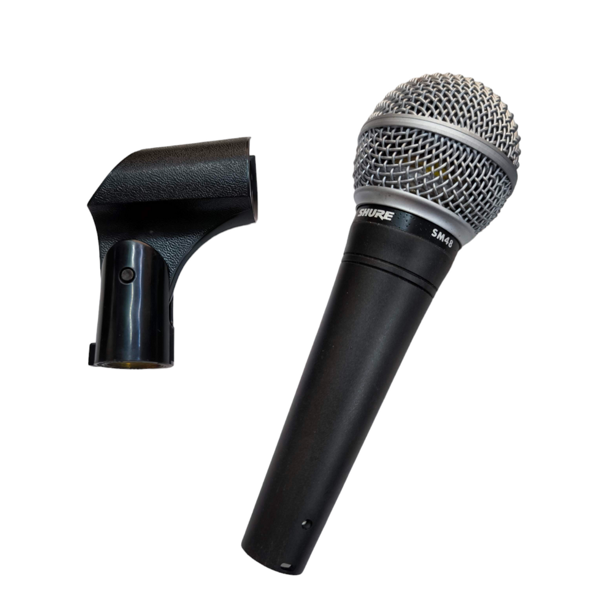 Shure Microphone Condenser with metal grille and black handle alongside black microphone clip