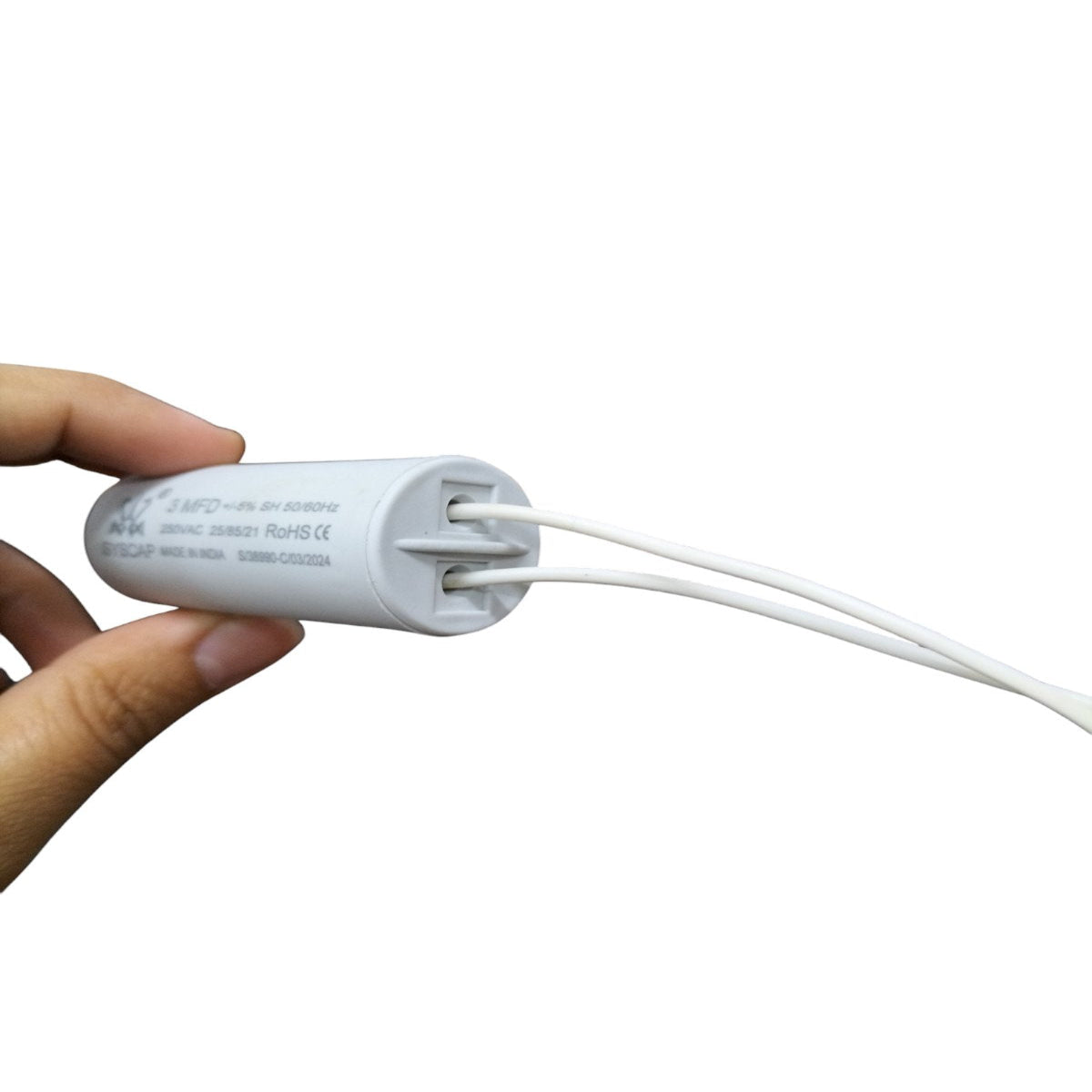 Hand holding SYSCAP 3MFD 250 VAC Running Capacitor with wires for electrical applications