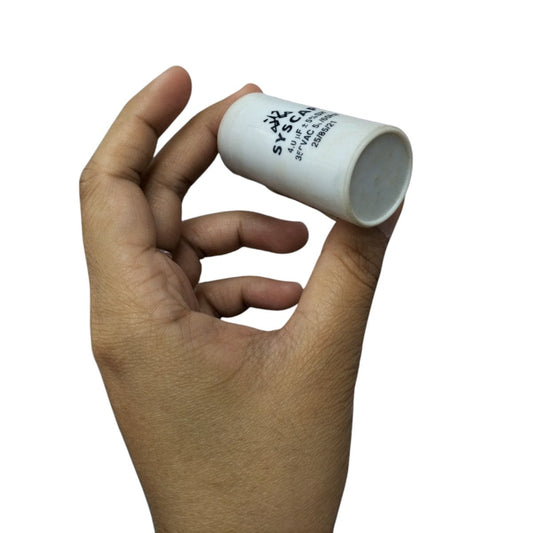 Hand holding Syscap 4MFD Motor Running Capacitor electrical part for motor circuits