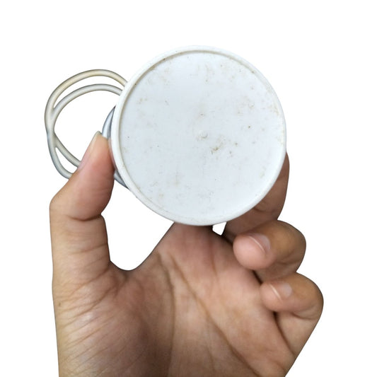 Hand holding a 70MFD 350 VAC Running Capacitor with white casing and connecting wires