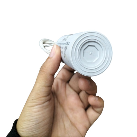 Syscap Motor Capacitor held in hand featuring a durable design for reliable electrical performance