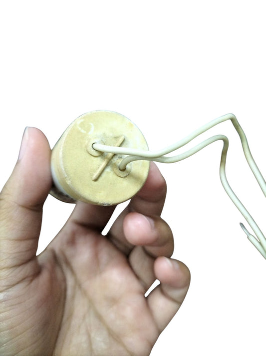 Hand holding SYSCAP Motor Running Capacitor 1MFD 600V AC with attached white wires