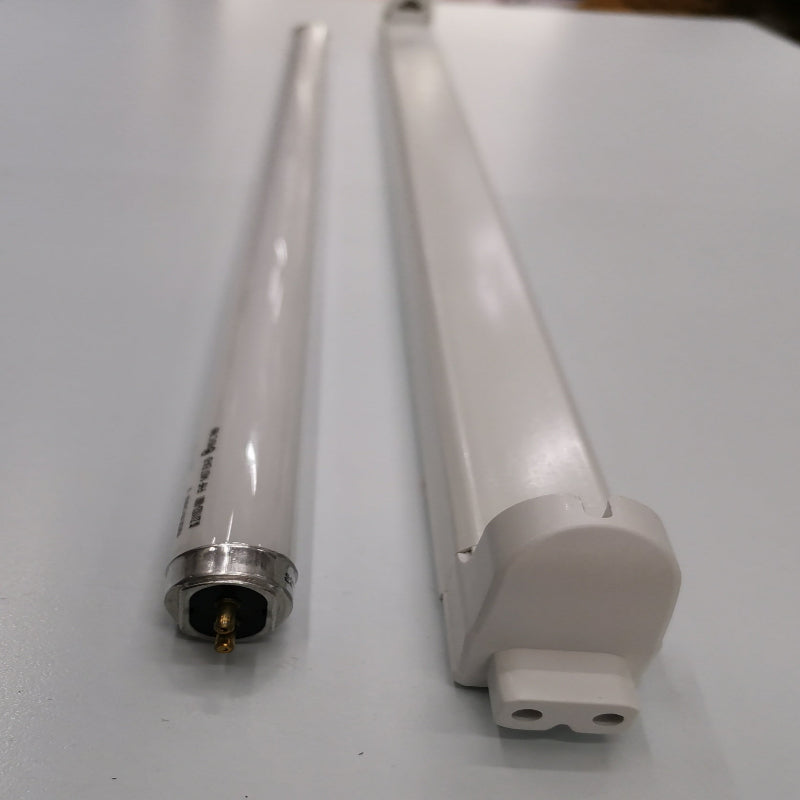 Philips T5 Fluorescent Lamp 28 Watts Daylight tube next to a white fluorescent fixture on a white surface