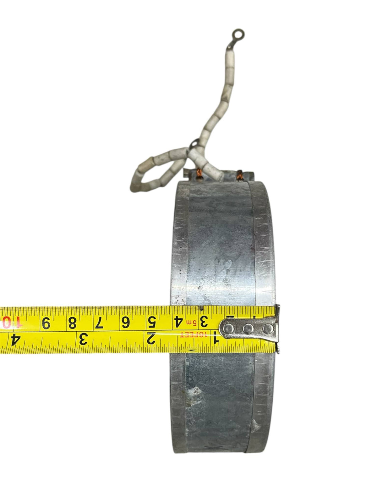 Local Thermos Heating Element 220V with metal coil and attached white insulated wires shown with measuring tape