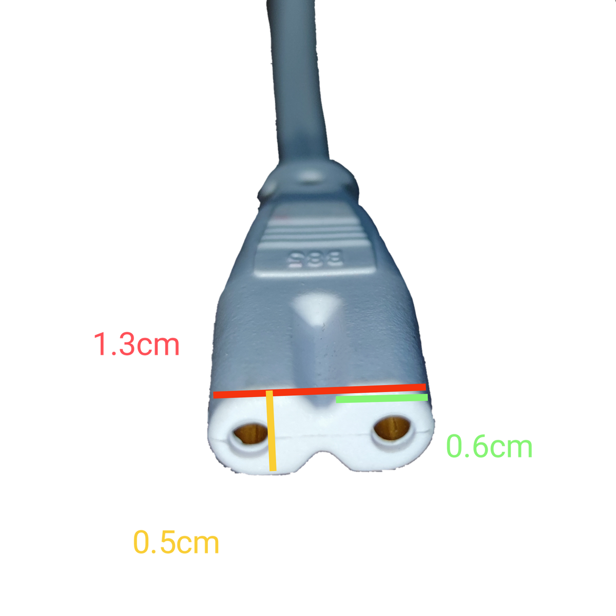 T-5 AC Connector 2 Pins white 2-pin power plug close up with cable and measurement markings on black background