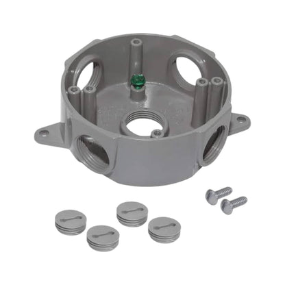 A gray cast-metal plumbing fitting or manifold component shown on a white background, accompanied by five matching gray caps and two silver screws.