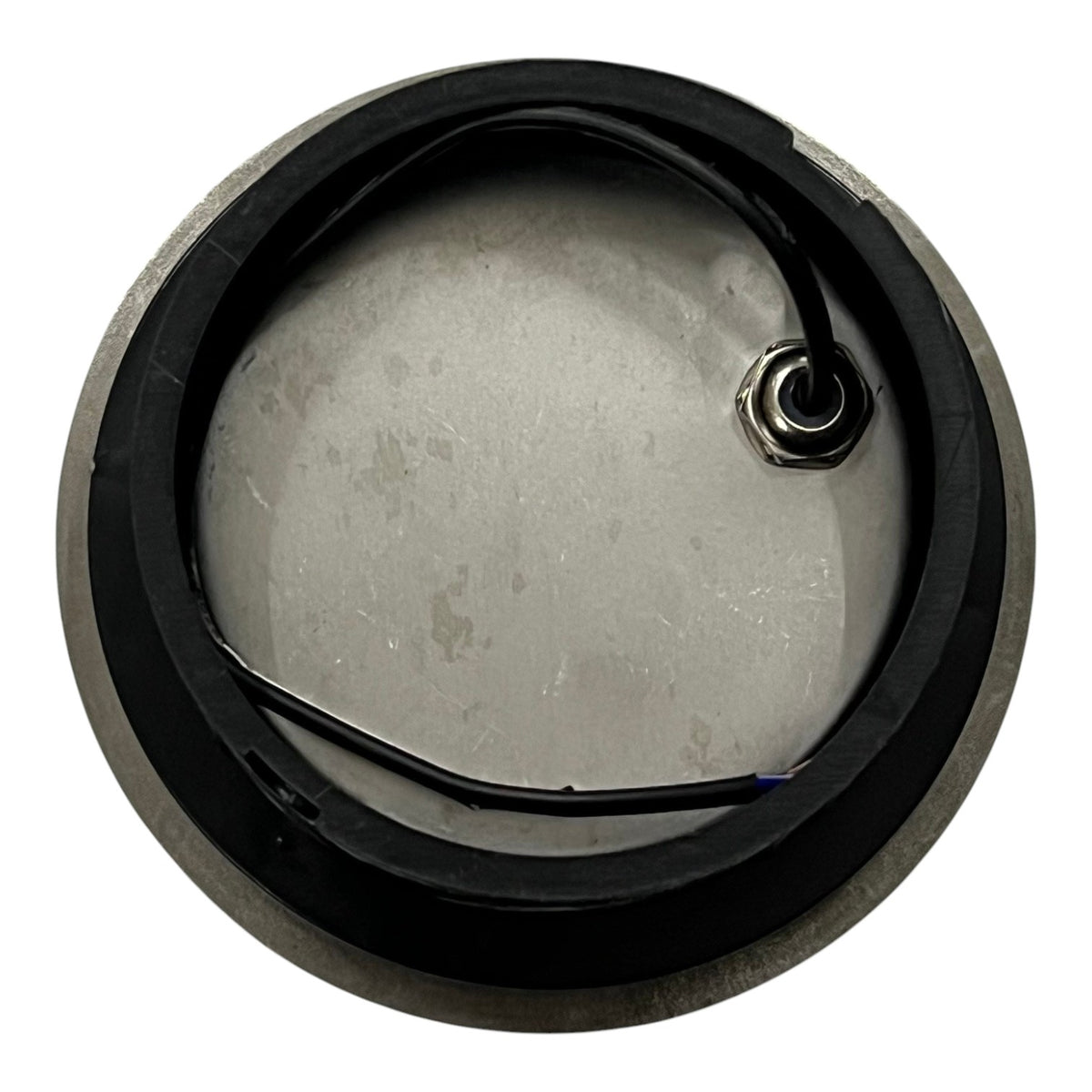 Metallic component with a black rim on a white background