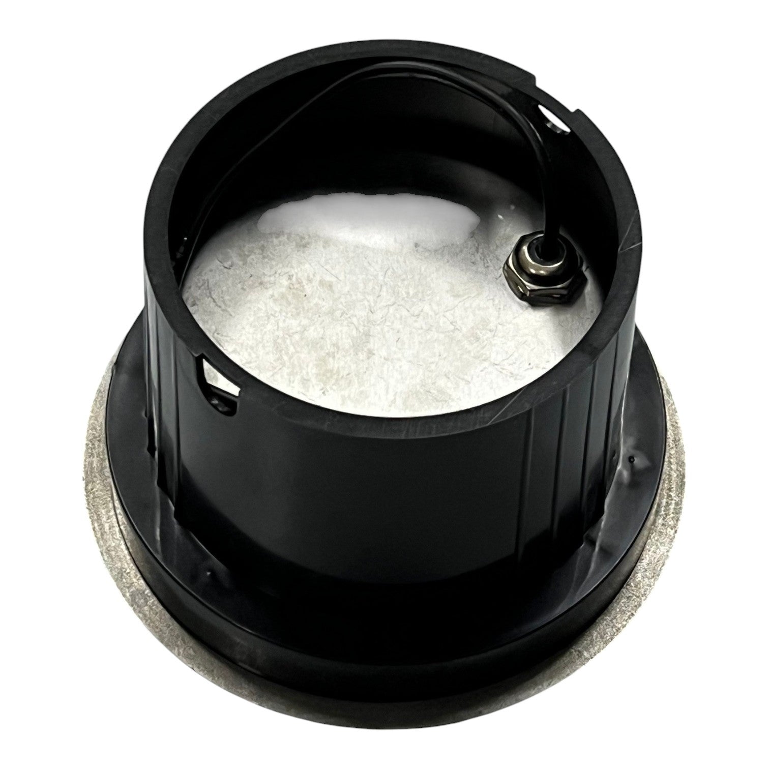 Black metal component with white powder inside on a white background