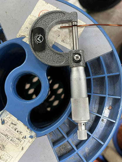 Philflex 14 AWG magnet wire 500G being measured with a micrometer for precision