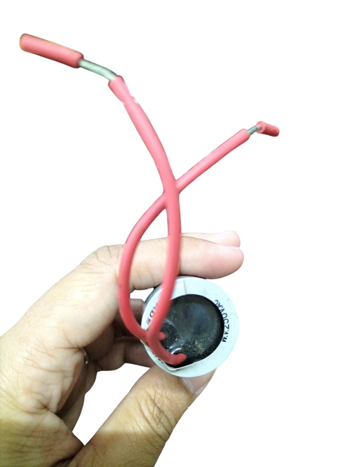 DRE 1MFD 250V AC motor running capacitor held in hand with red wiring for electrical applications